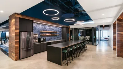 Circle ring lights appearing above a coffee bar/kitchen and island space.