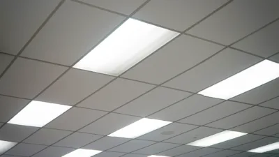 Troffer ceiling lights between ceiling panels.